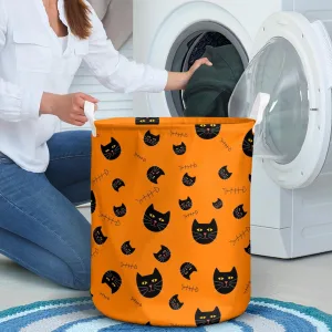 The Black Cat With Yellow Eyes And The Fish Skull On The Orange Laundry Basket